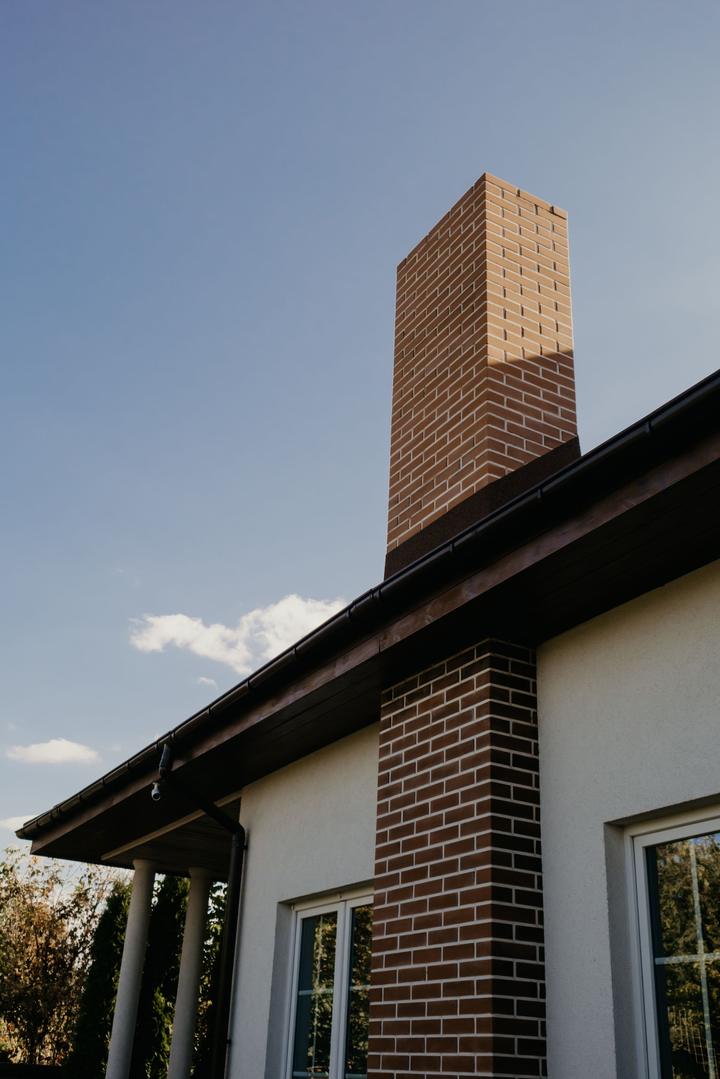 Brick chimney beside the siding of a house